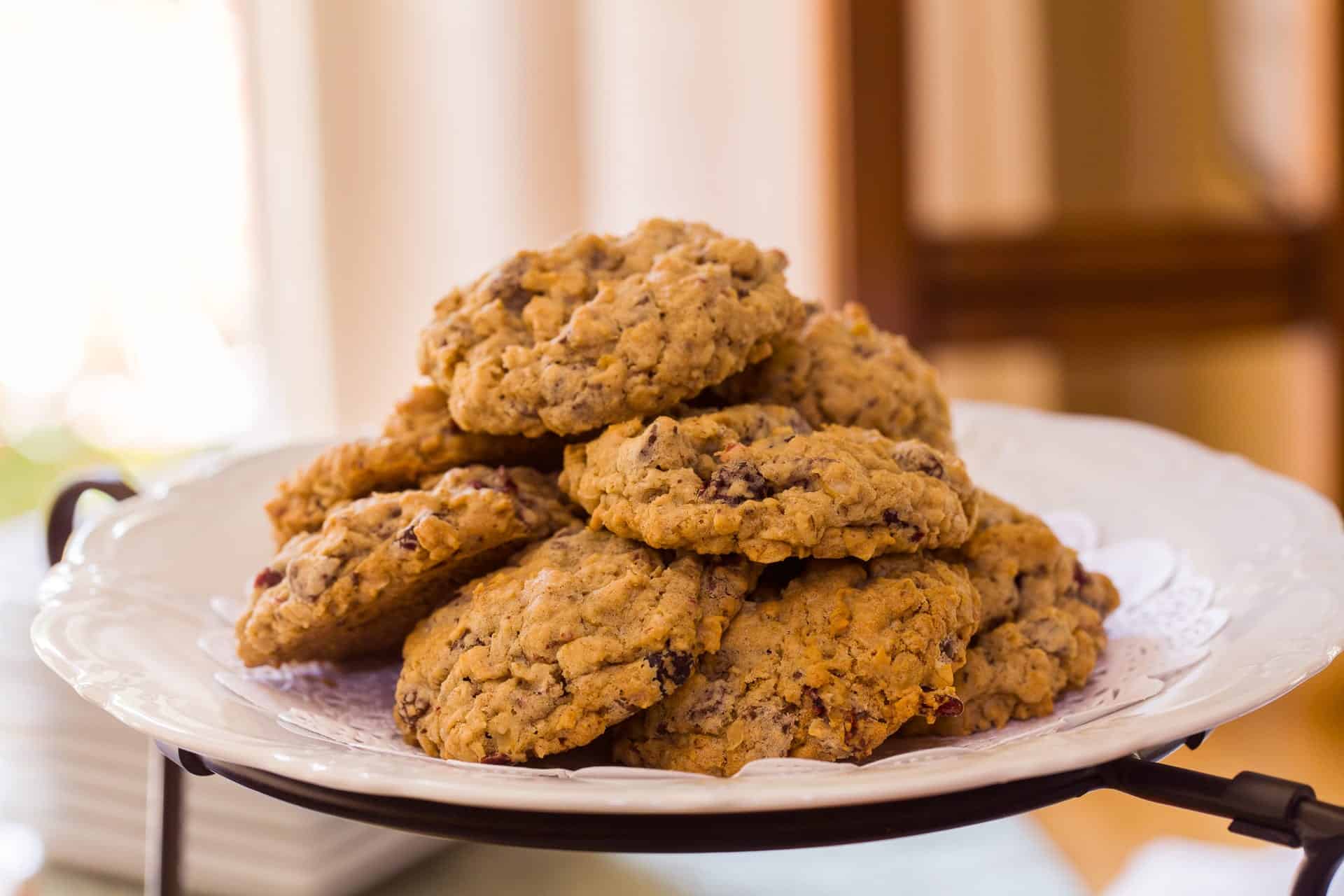 A plate stacked with freshly baked oatmeal cookies. A plate stacked with freshly baked oatmeal cookies.