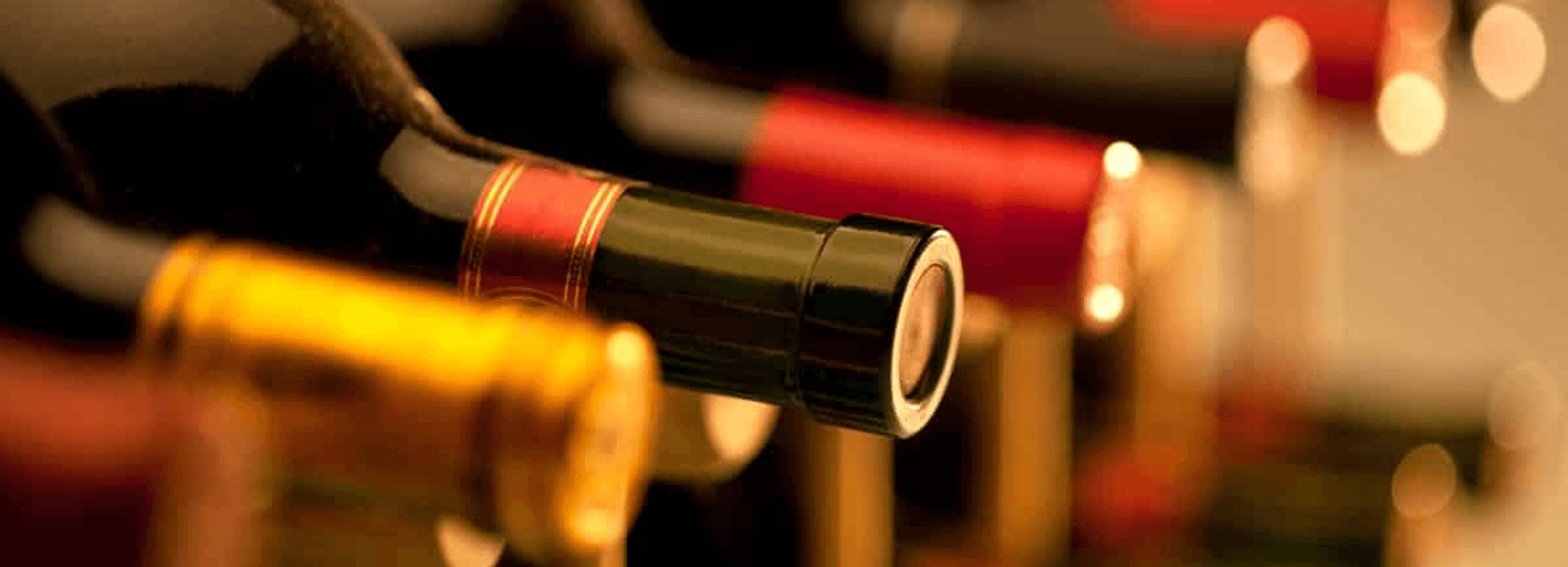 A close-up of wine bottle tops in various colors.