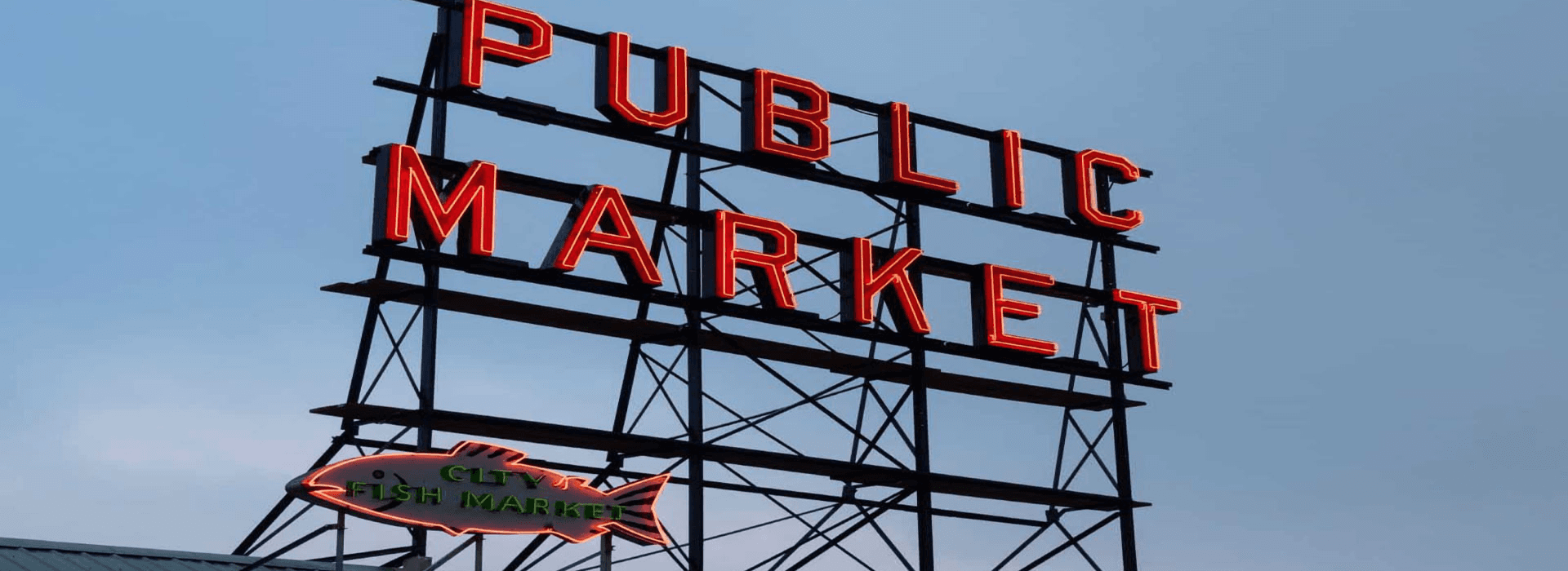 Neon sign for a public market with "PUBLIC MARKET" and a fish symbol below.