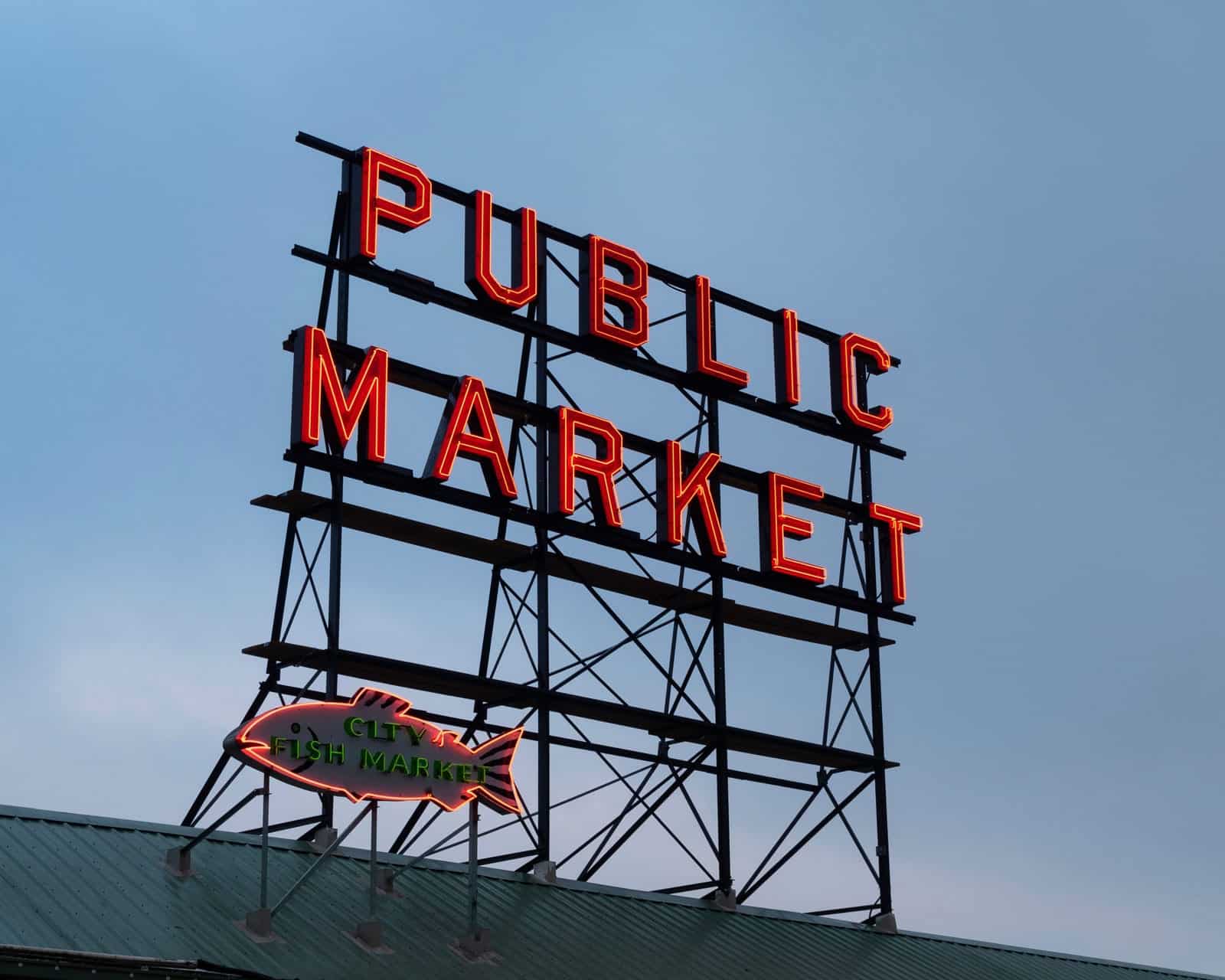 Neon sign reading "PUBLIC MARKET" above a fish market. Neon sign reading "PUBLIC MARKET" above a fish market.