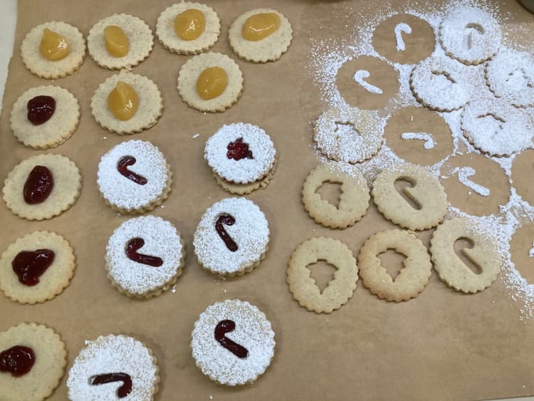 rolled out linzer cookies on parchment paper