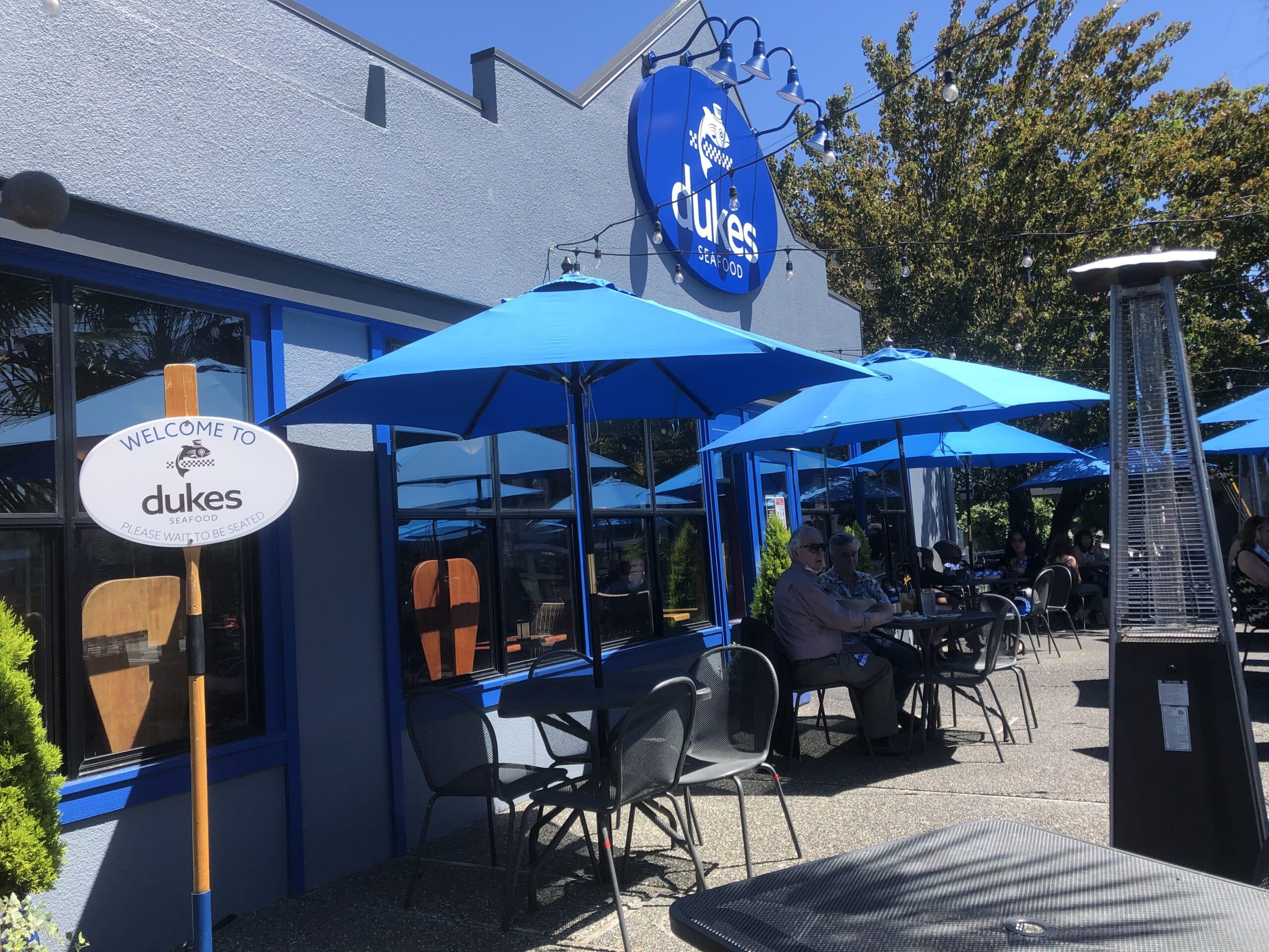 Patio at Duke's restaurant with blue umbrellas