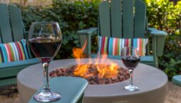 firepit with chairs and glass of wine