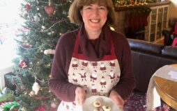 woman holding plate of cookies in front of tree