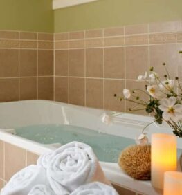 Parview Bathroom with a full tub and candle lit on the side of the tub for a relaxing weekend