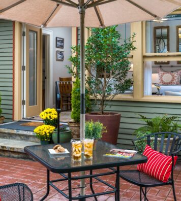 outdoor patio table with umbrella and snacks